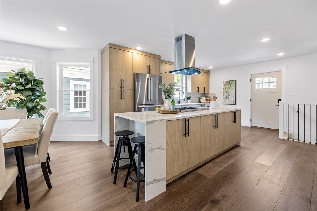 58 Simpson Avenue, Unit 2 Somerville, MA 02144 - Photo 6 of 28 a kitchen with a table chairs refrigerator and microwave