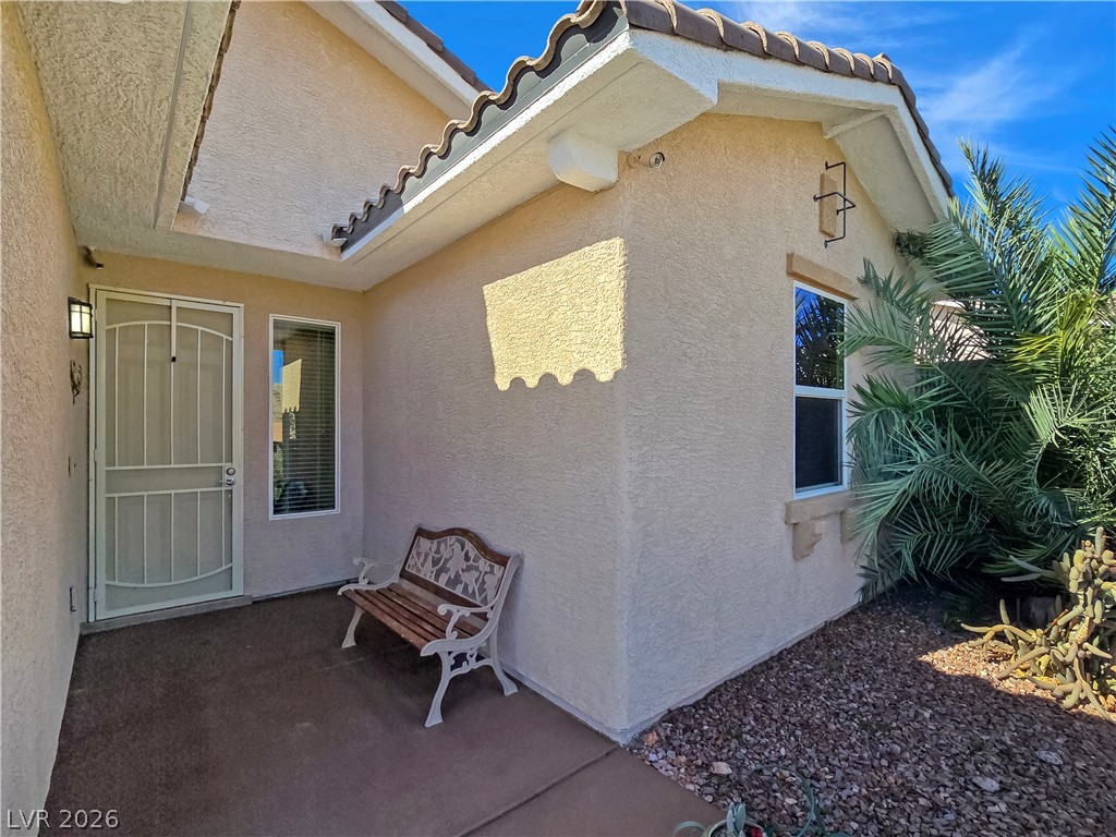 2485 Morrow Ridge Place Laughlin, NV 89029 - Photo 5 of 40 A welcoming front entry features durable stucco, traditional tile roofing, and desert-friendly landscaping.