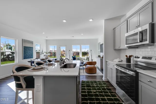a kitchen with sink a stove and cabinets