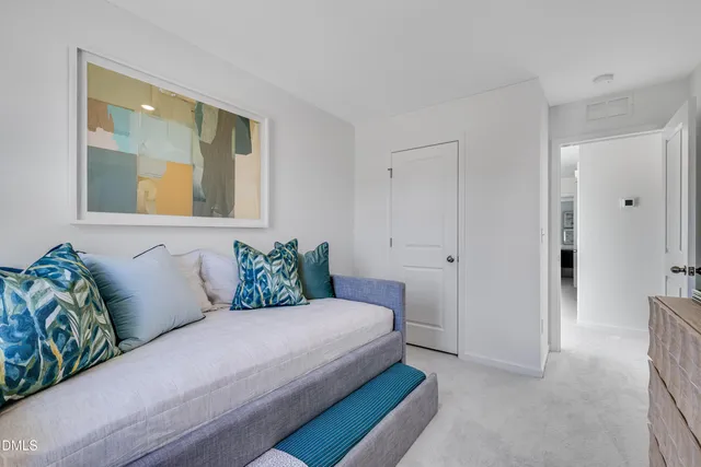 a bedroom with a large bed and a couch