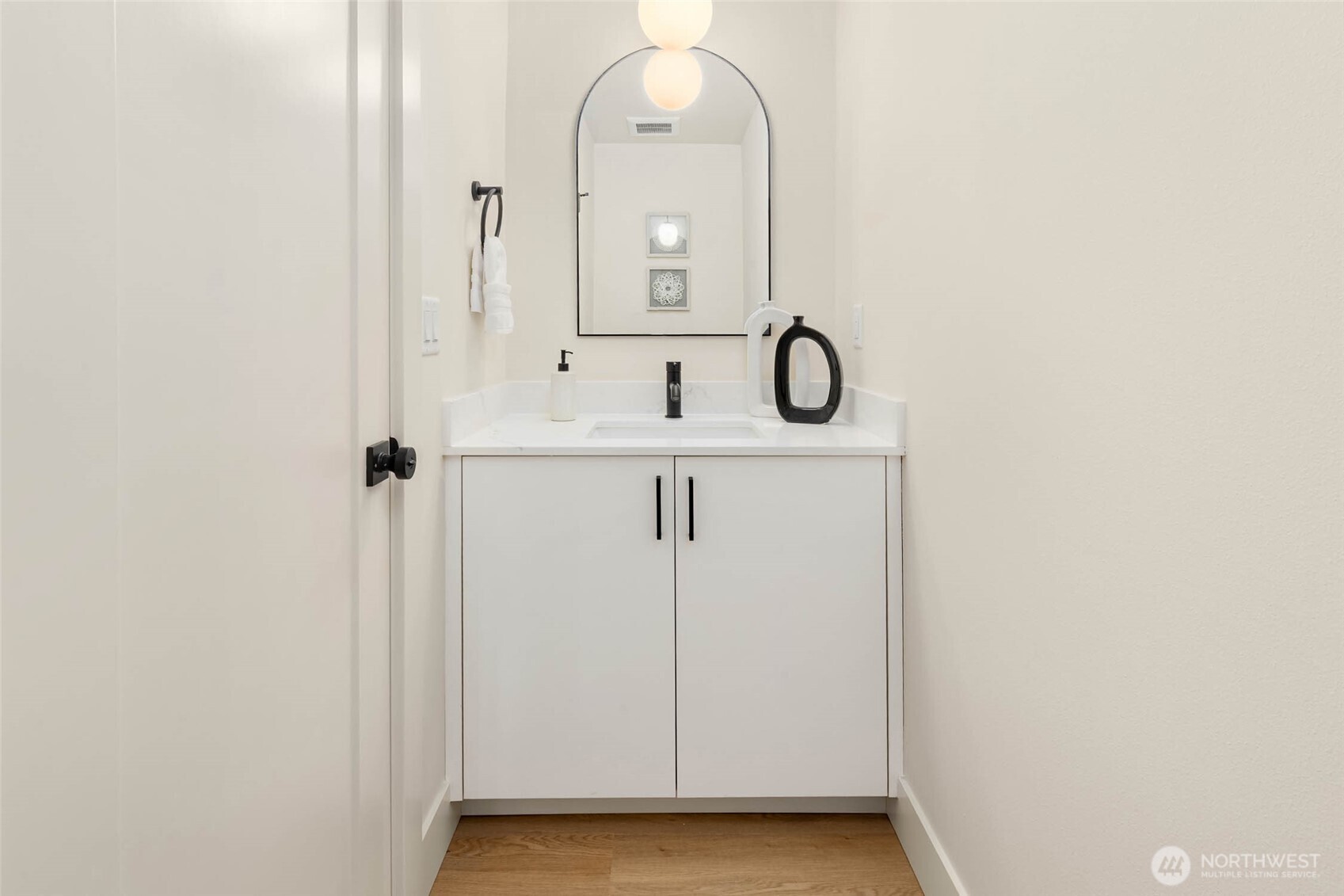 3812 South Eddy Street Seattle, WA 98118 - Photo 14 of 19 a bathroom with a sink a light fixture and a mirror
