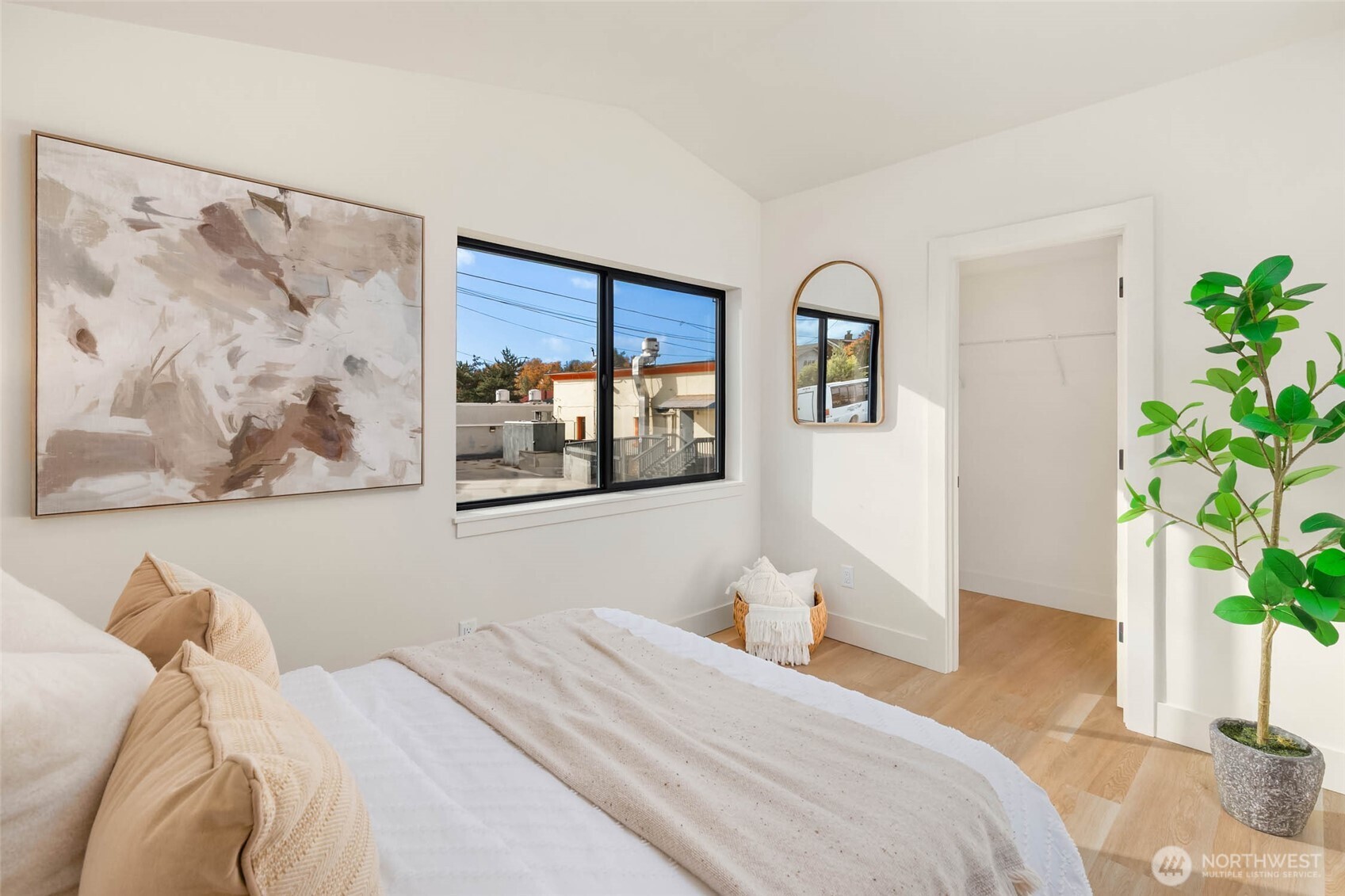 3812 South Eddy Street Seattle, WA 98118 - Photo 16 of 19 a bedroom with a large bed and a potted plant