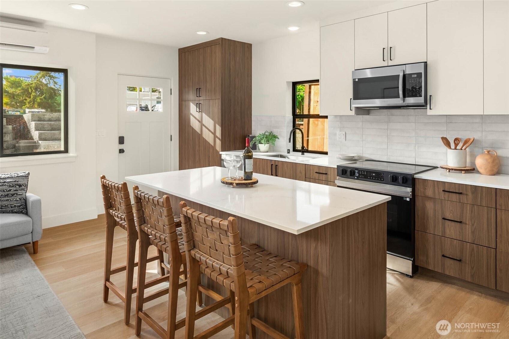 3812 South Eddy Street Seattle, WA 98118 - Photo 8 of 19 a kitchen with stainless steel appliances kitchen island granite countertop a sink a microwave cabinets and a refrigerator