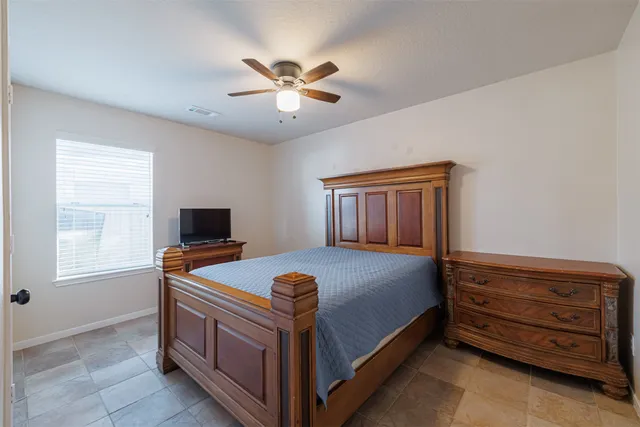 a bedroom with a bed and window