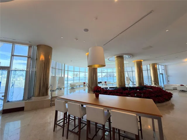 a kitchen with a table chairs sink and cabinets