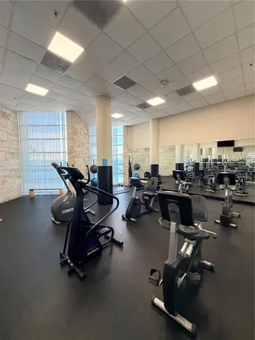 a room with gym equipment and a large window