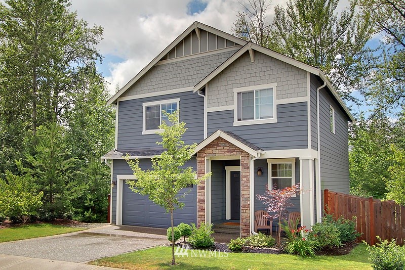 325 Field Place Northeast Renton, WA 98059 - Photo 1 of 13 a front view of a house with garden