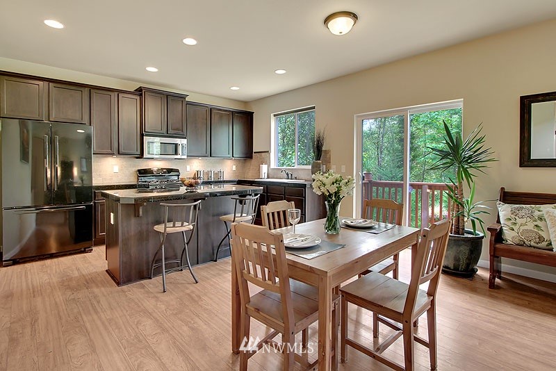 325 Field Place Northeast Renton, WA 98059 - Photo 3 of 13 a kitchen with stainless steel appliances granite countertop a stove a refrigerator a kitchen island a table and chairs