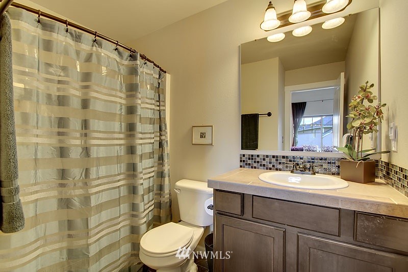 325 Field Place Northeast Renton, WA 98059 - Photo 10 of 13 a bathroom with a sink toilet vanity and shower
