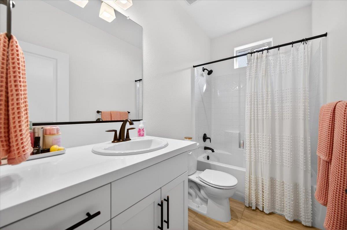 4593 Orchard Hills Road Madera, CA 93636 - Photo 6 of 25 a bathroom with a toilet a sink and a mirror