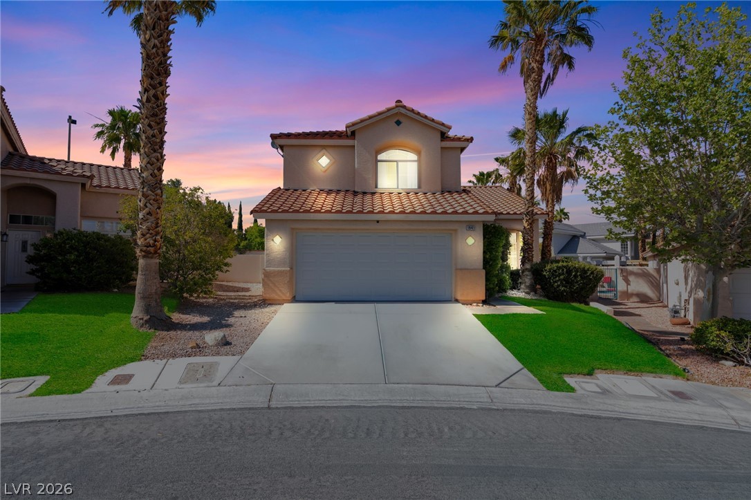 1941 Ivy Point Lane Las Vegas, NV 89134 - Photo 2 of 21 This residence showcases a traditional facade with a two-car garage and manicured landscaping.