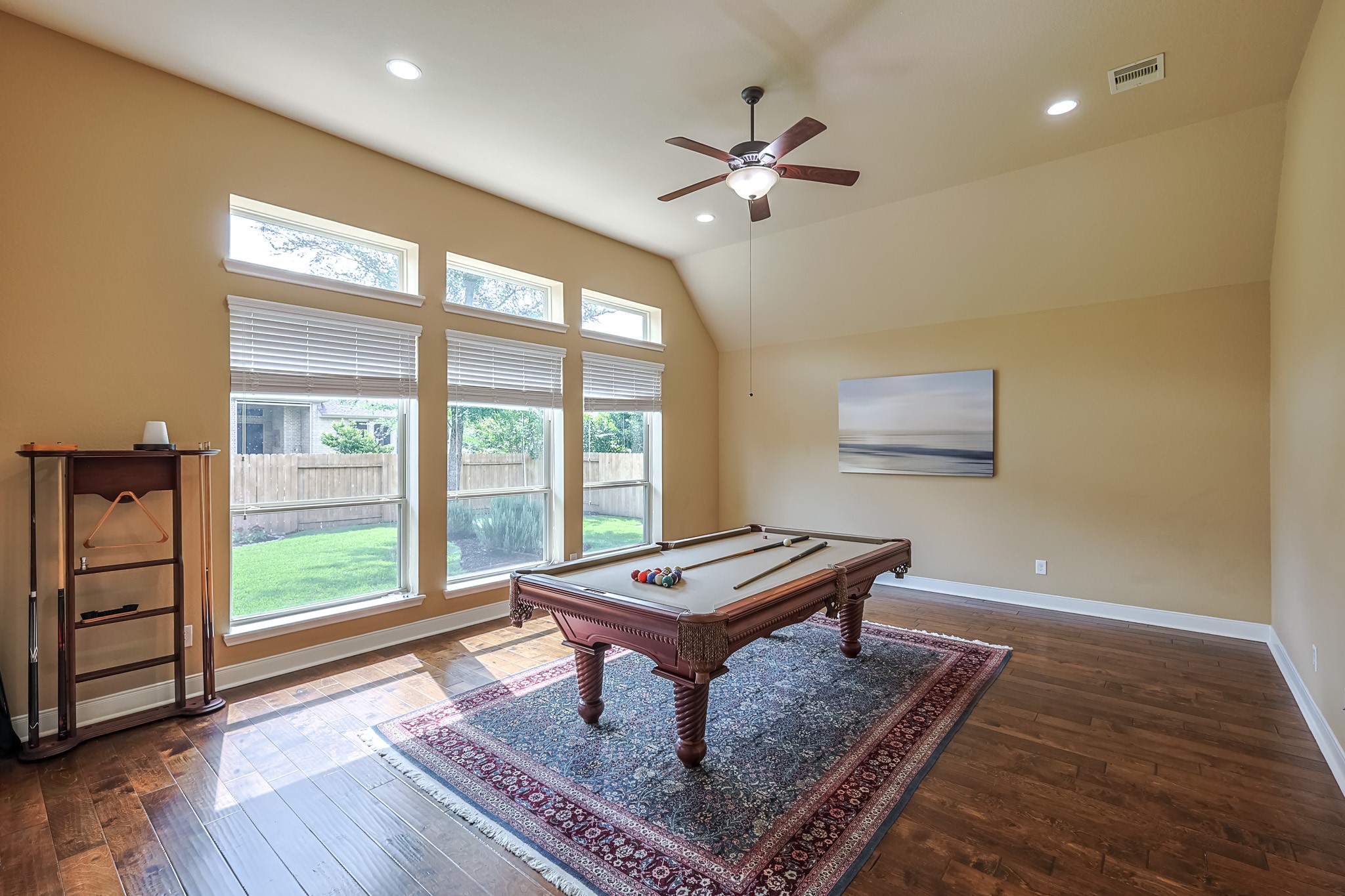 515 Mill Creek Road Pinehurst, TX 77362 - Photo 36 of 48 Bright game room with large windows, hardwood floors, and a ceiling fan. Pool table can be included in sale.