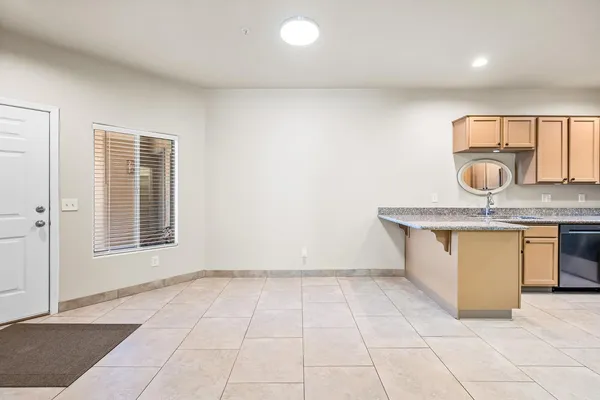 a view of kitchen with granite countertop cabinets