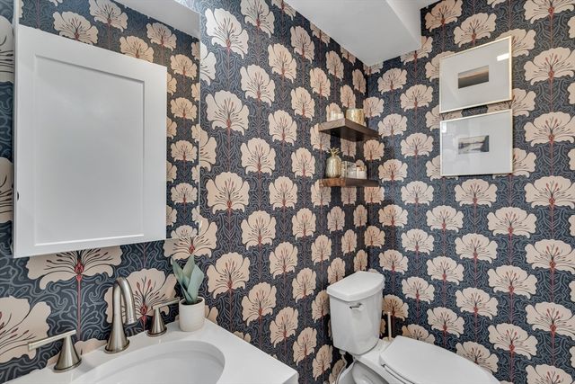 a white toilet sitting next to a shower curtain