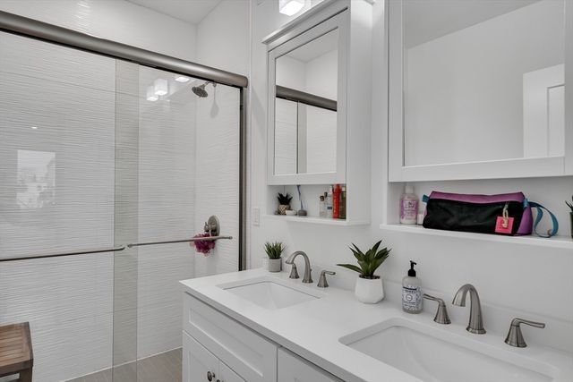 a bathroom with a double vanity sink and a mirror