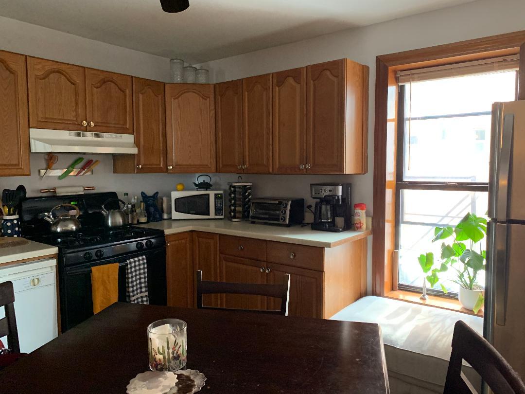 838 North State Street, Unit 2 Chicago, IL 60654 - Photo 3 of 3 a kitchen with stainless steel appliances granite countertop a stove a sink and a refrigerator