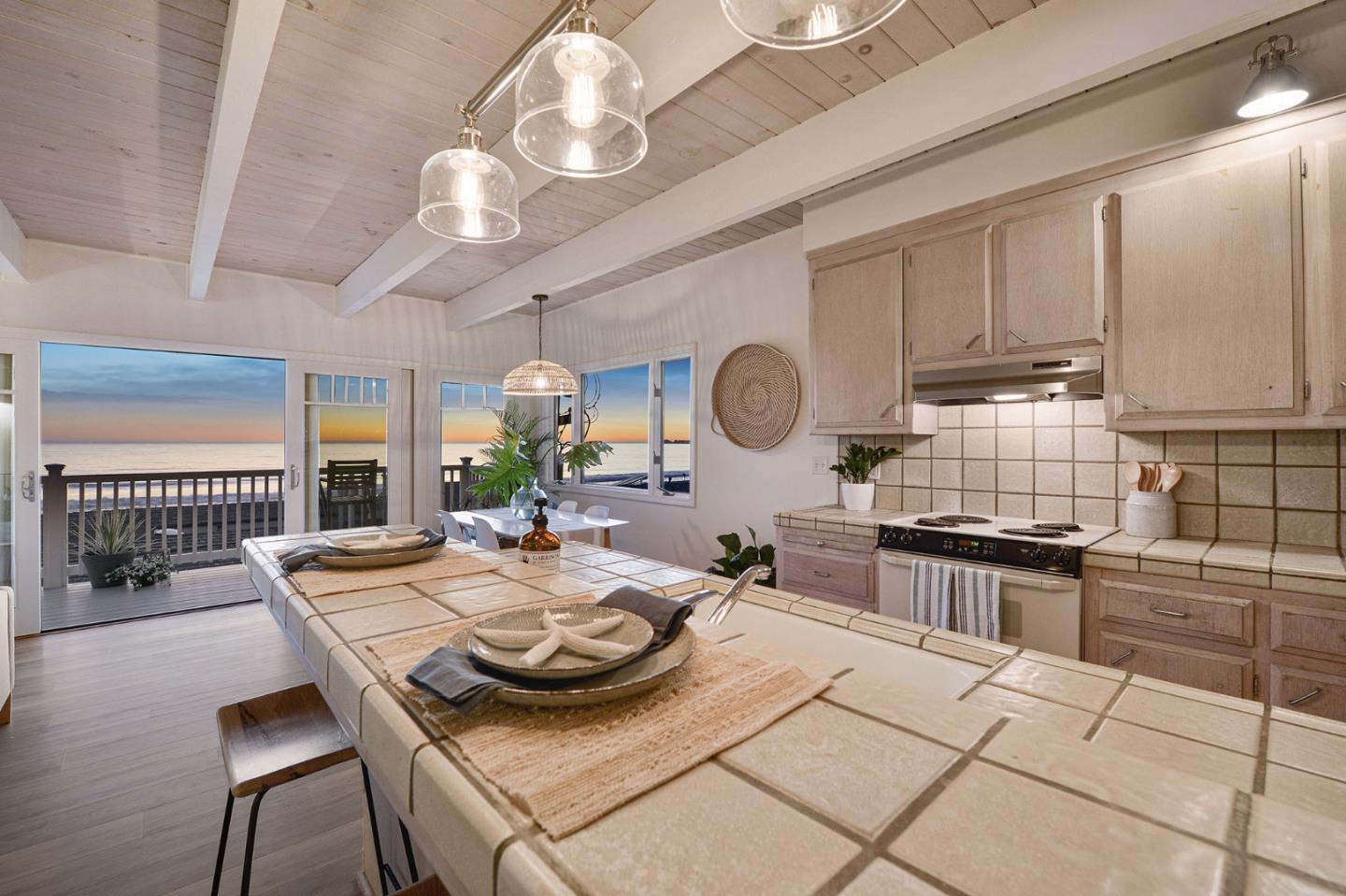 615 Beach Drive Aptos, CA 95003 - Photo 3 of 37 a kitchen with a stove a sink a dining table and chairs