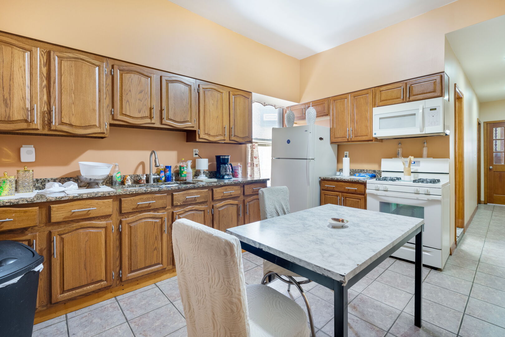 2312 West Taylor Street Chicago, IL 60612 - Photo 7 of 13 a kitchen with a table chairs refrigerator and cabinets
