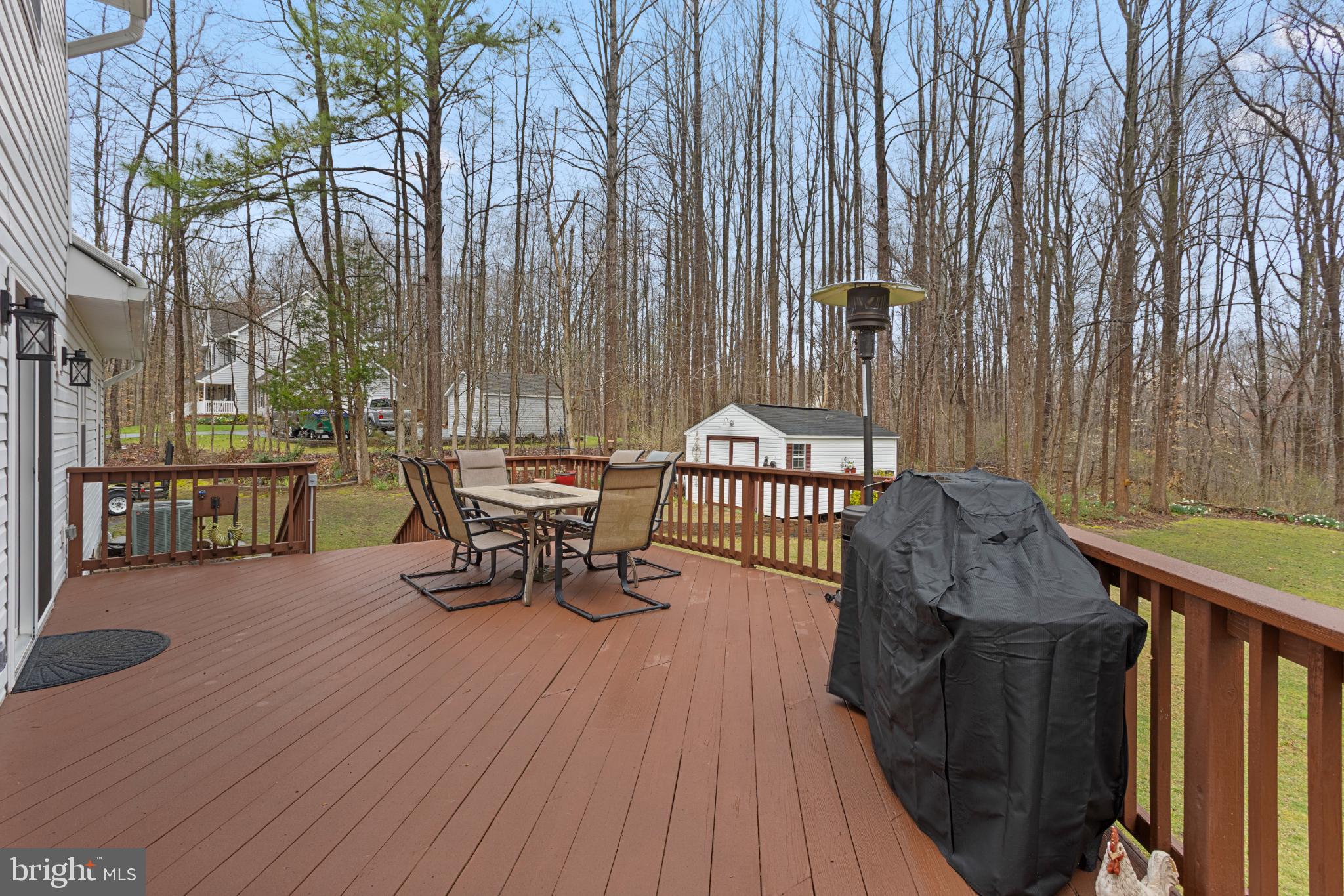 1860 Battery Lane Owings, MD 20736 - Photo 107 of 120 a view of a patio with table and chairs with wooden floor and fence