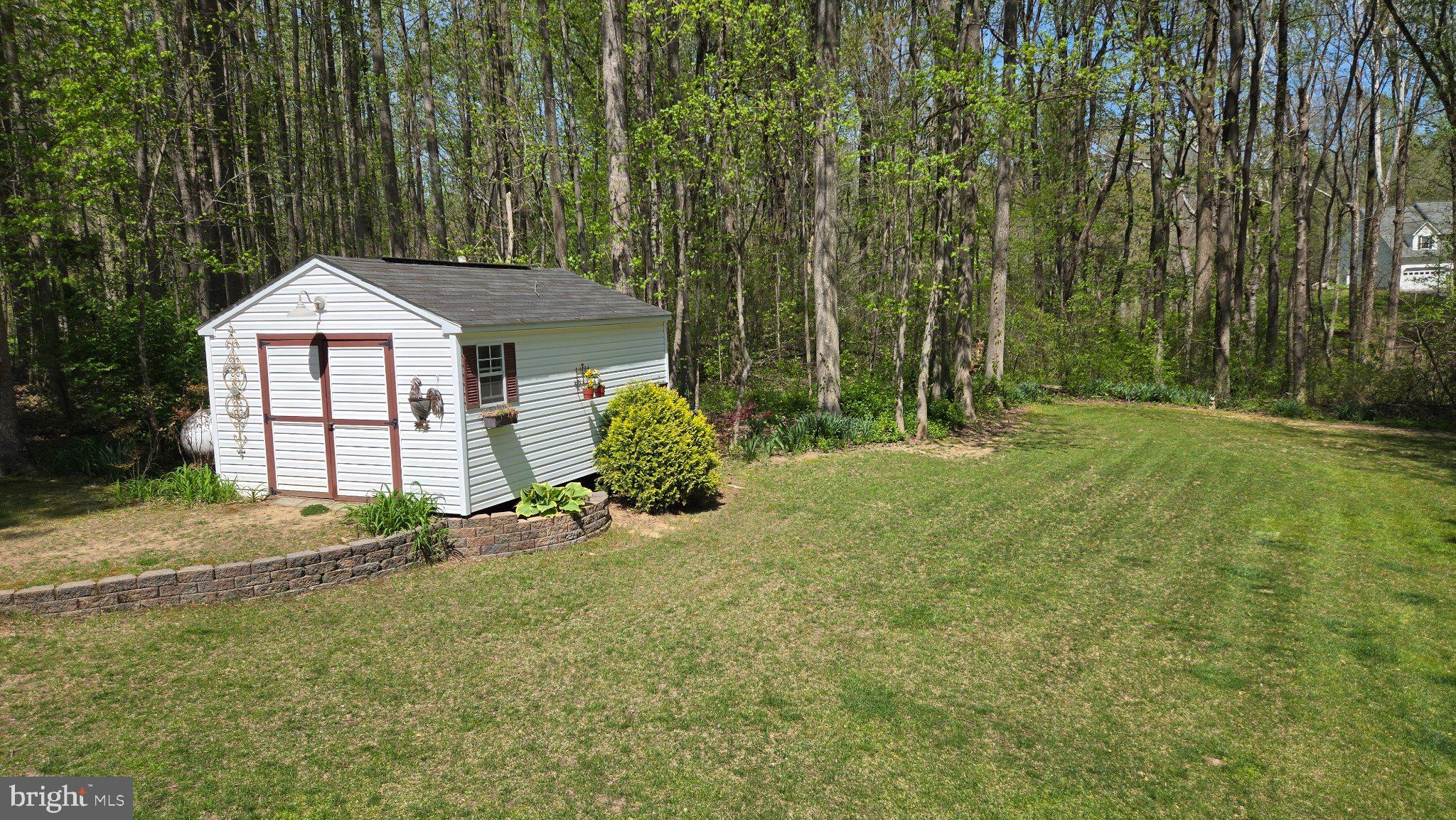 1860 Battery Lane Owings, MD 20736 - Photo 109 of 120 Charming shed nestled in lush greenery.