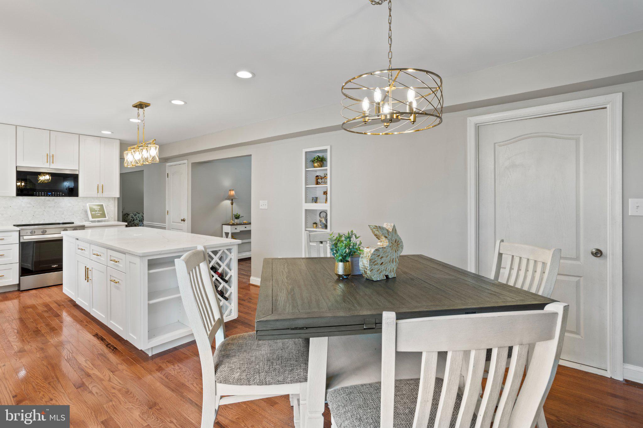 1860 Battery Lane Owings, MD 20736 - Photo 18 of 120 a view of a dining room with furniture a chandelier and wooden floor