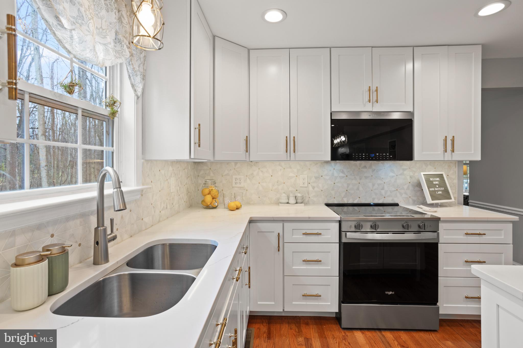 1860 Battery Lane Owings, MD 20736 - Photo 22 of 120 a kitchen with granite countertop a sink a stove and cabinets