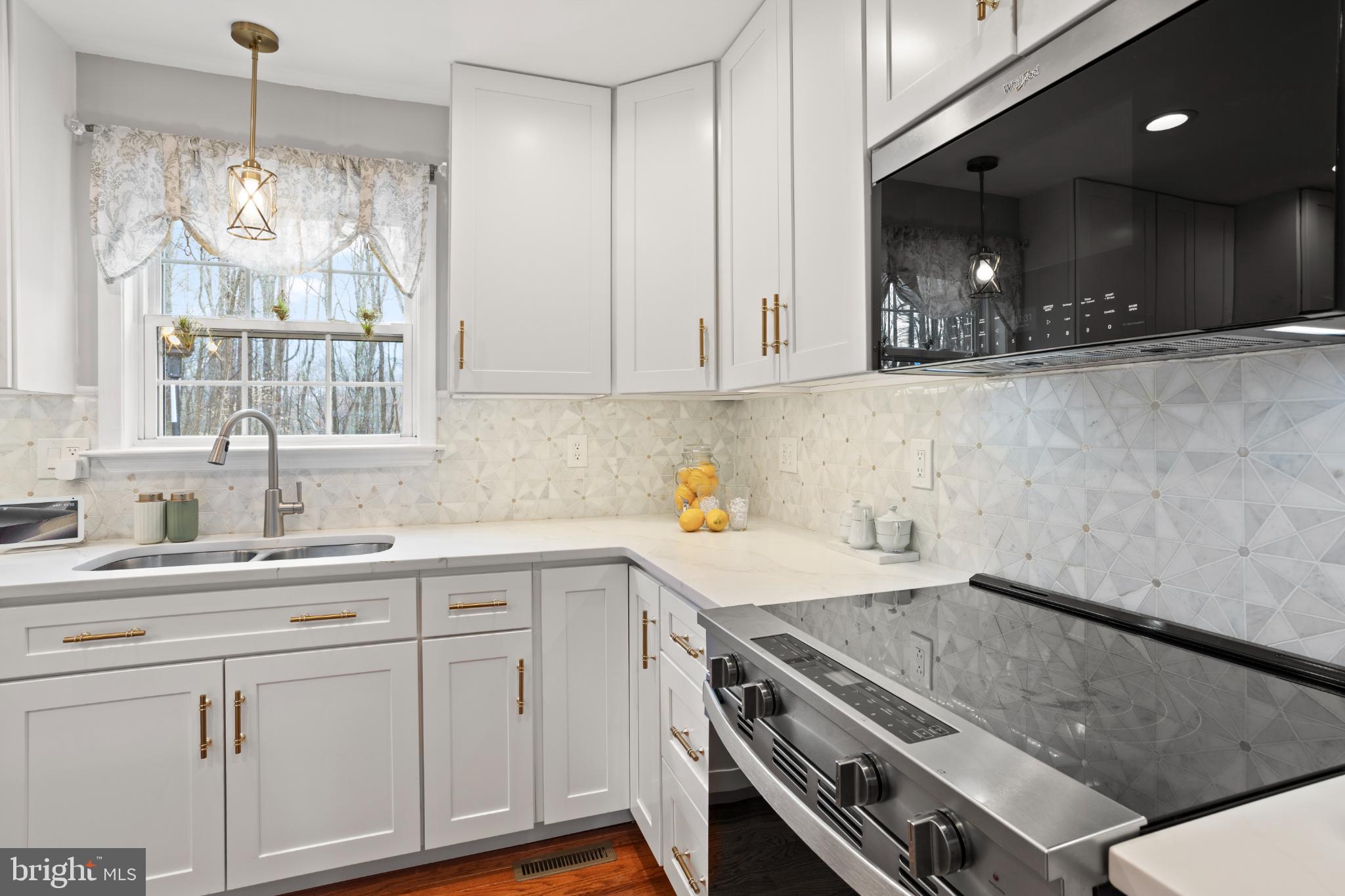 1860 Battery Lane Owings, MD 20736 - Photo 23 of 120 a kitchen with a sink stove and cabinets