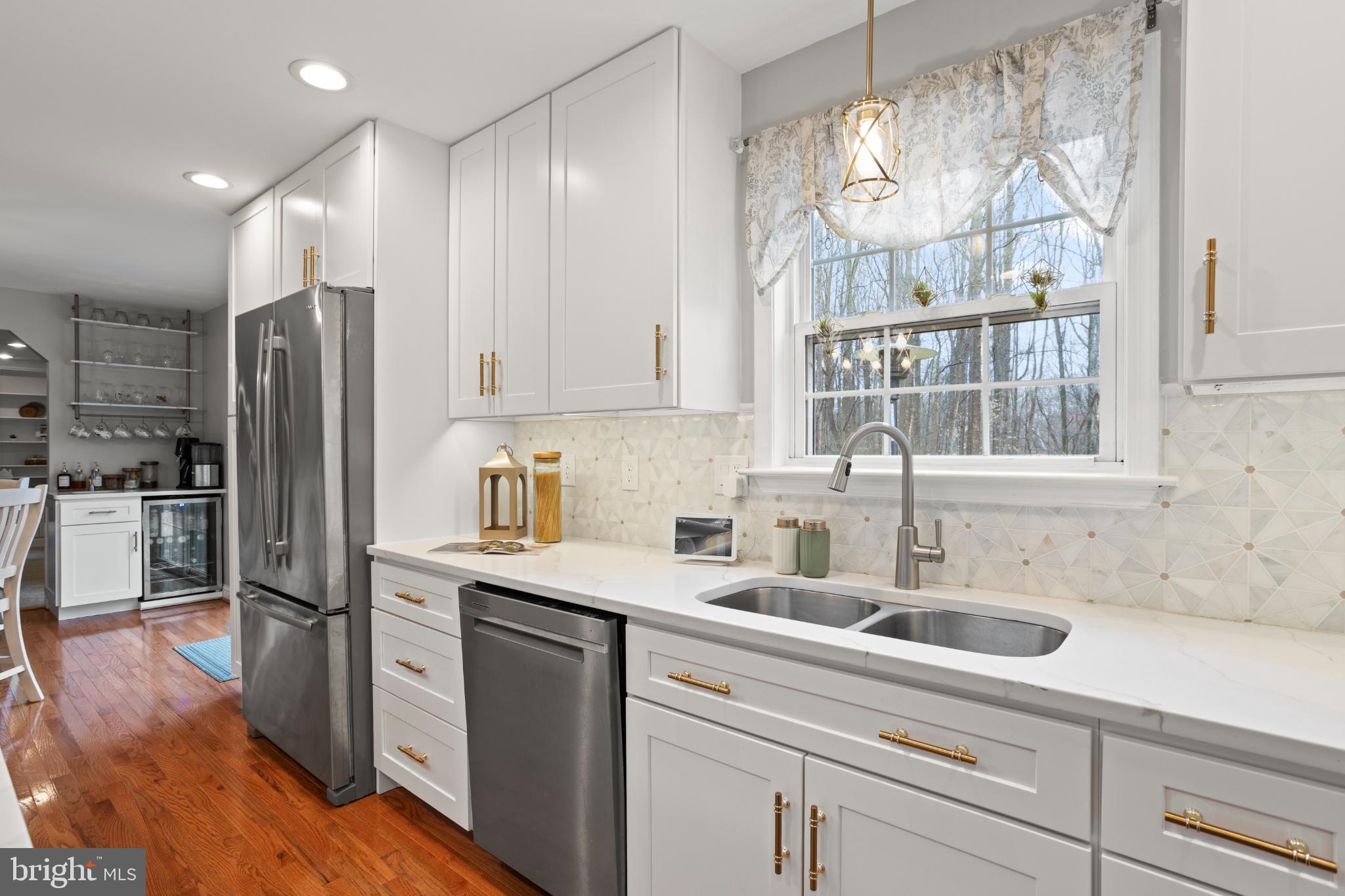 1860 Battery Lane Owings, MD 20736 - Photo 25 of 120 a kitchen with a sink a refrigerator and cabinets