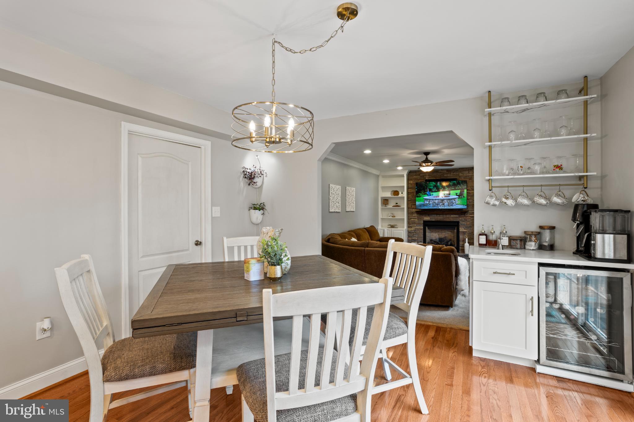 1860 Battery Lane Owings, MD 20736 - Photo 29 of 120 a view of a dining room with furniture a chandelier and wooden floor