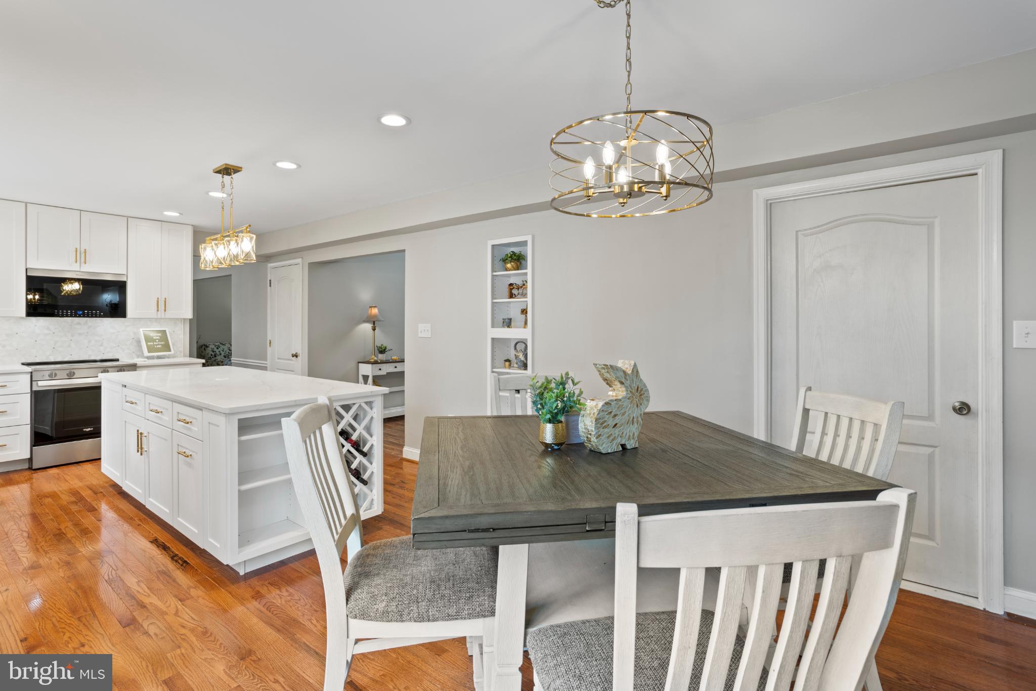 1860 Battery Lane Owings, MD 20736 - Photo 30 of 120 a view of a dining room with furniture a chandelier and wooden floor