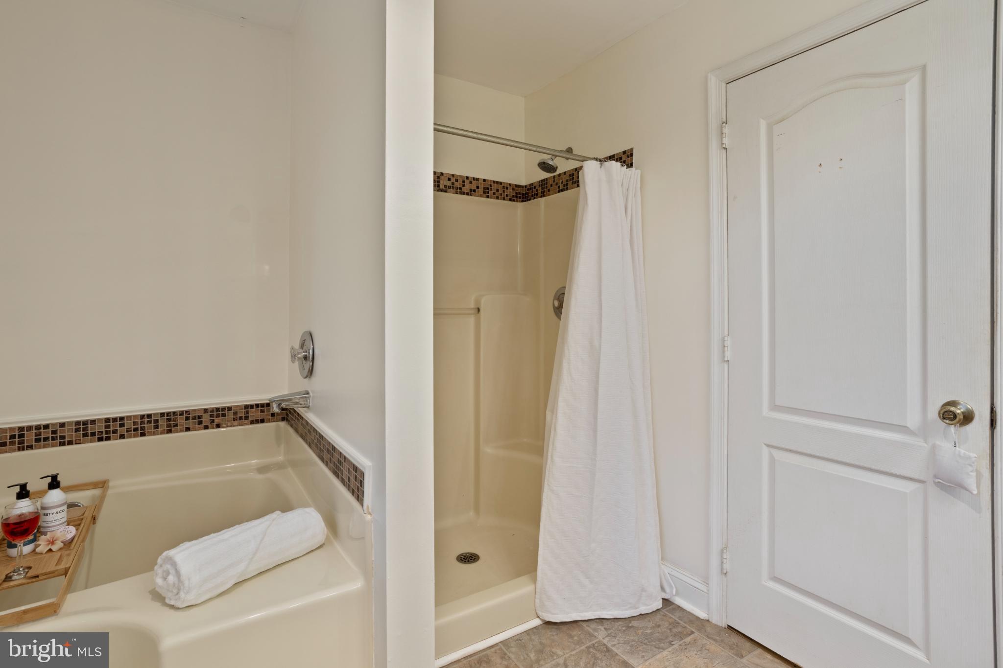 1860 Battery Lane Owings, MD 20736 - Photo 59 of 120 a bathroom with a tub and shower
