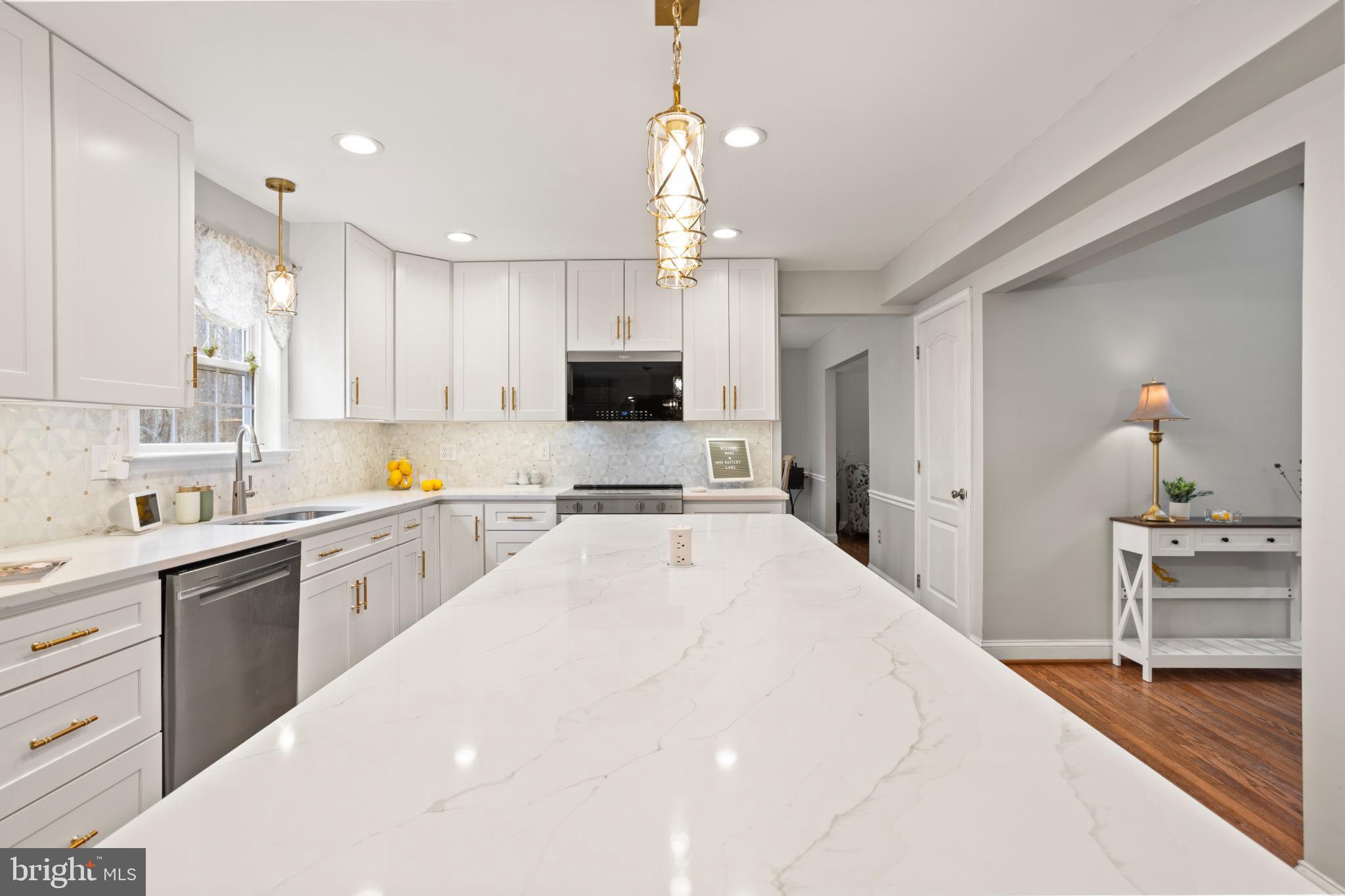 1860 Battery Lane Owings, MD 20736 - Photo 6 of 120 a large kitchen with kitchen island a sink stainless steel appliances and cabinets