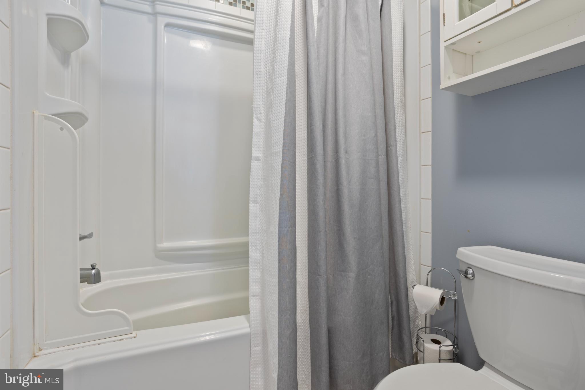 1860 Battery Lane Owings, MD 20736 - Photo 62 of 120 a bathroom with a shower and a toilet