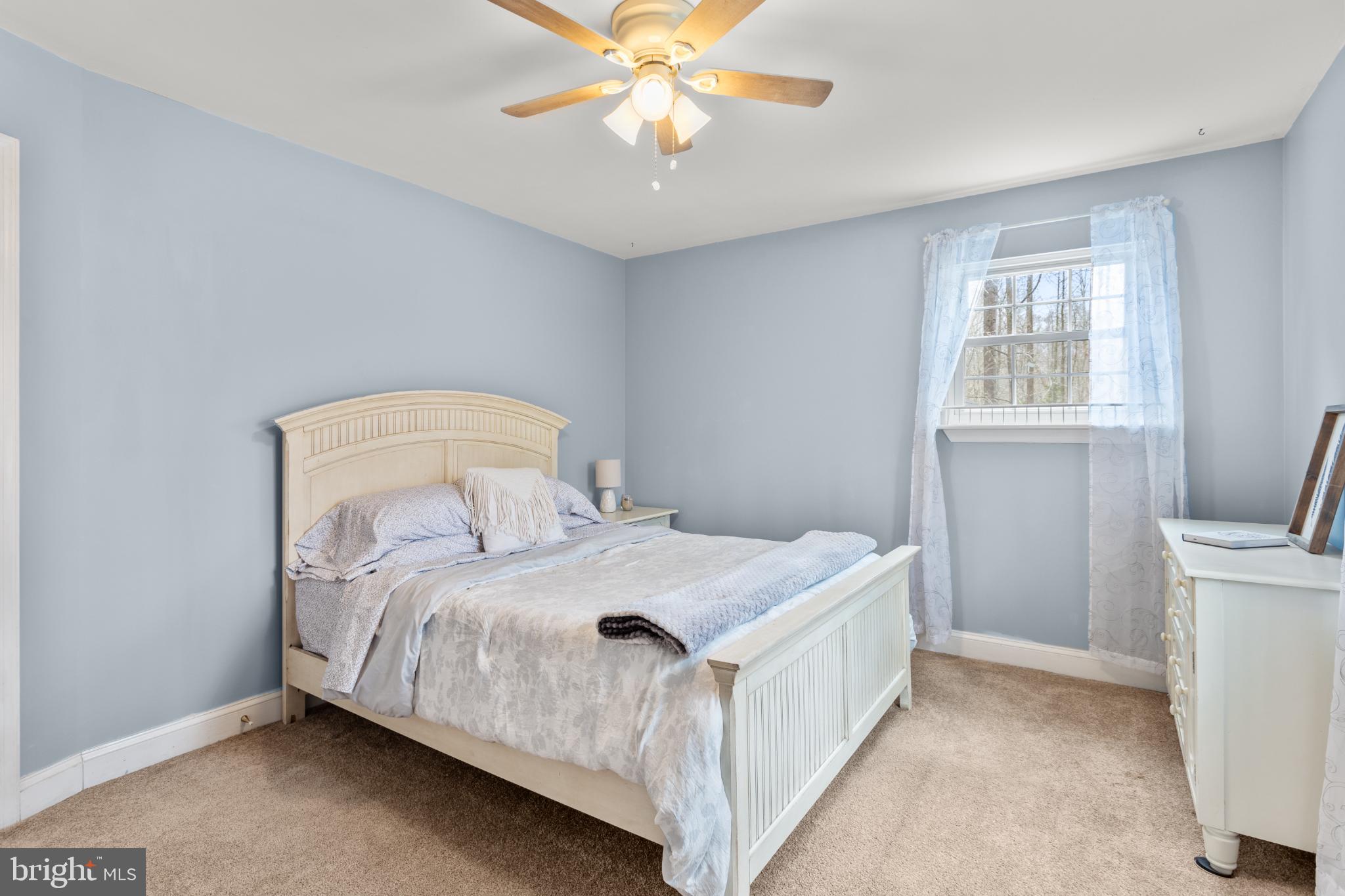 1860 Battery Lane Owings, MD 20736 - Photo 71 of 120 a bedroom with a bed and a chandelier