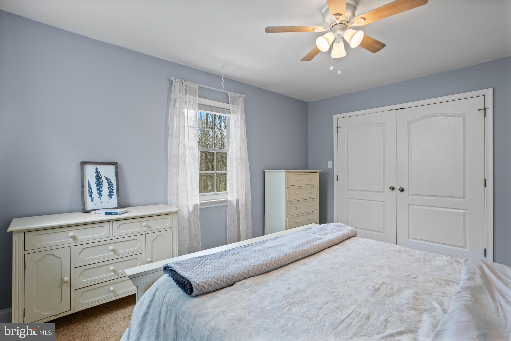 1860 Battery Lane Owings, MD 20736 - Photo 74 of 120 a bedroom with a bed and a chandelier