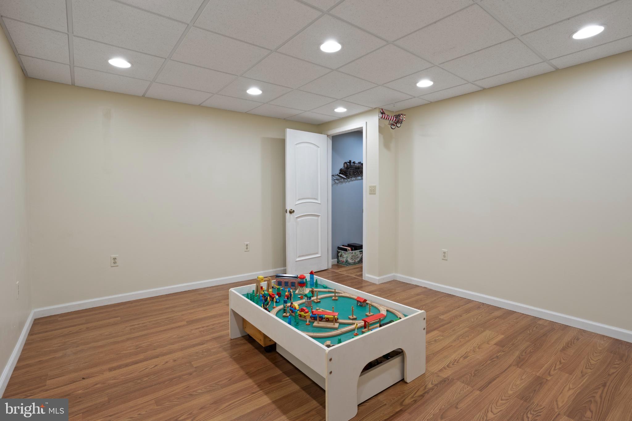 1860 Battery Lane Owings, MD 20736 - Photo 89 of 120 a living room with hard wood floor and a ceiling fan