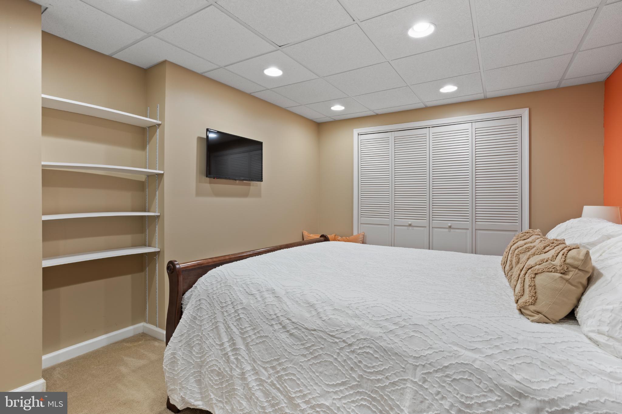 1860 Battery Lane Owings, MD 20736 - Photo 100 of 120 a bedroom with a large bed and a flat tv screen