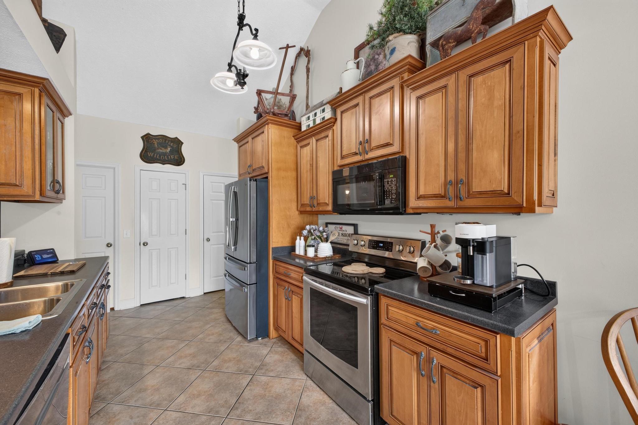 42 Emerald Ridge Aiken, SC 29803 - Photo 11 of 33 a kitchen with stainless steel appliances granite countertop a stove refrigerator sink and microwave