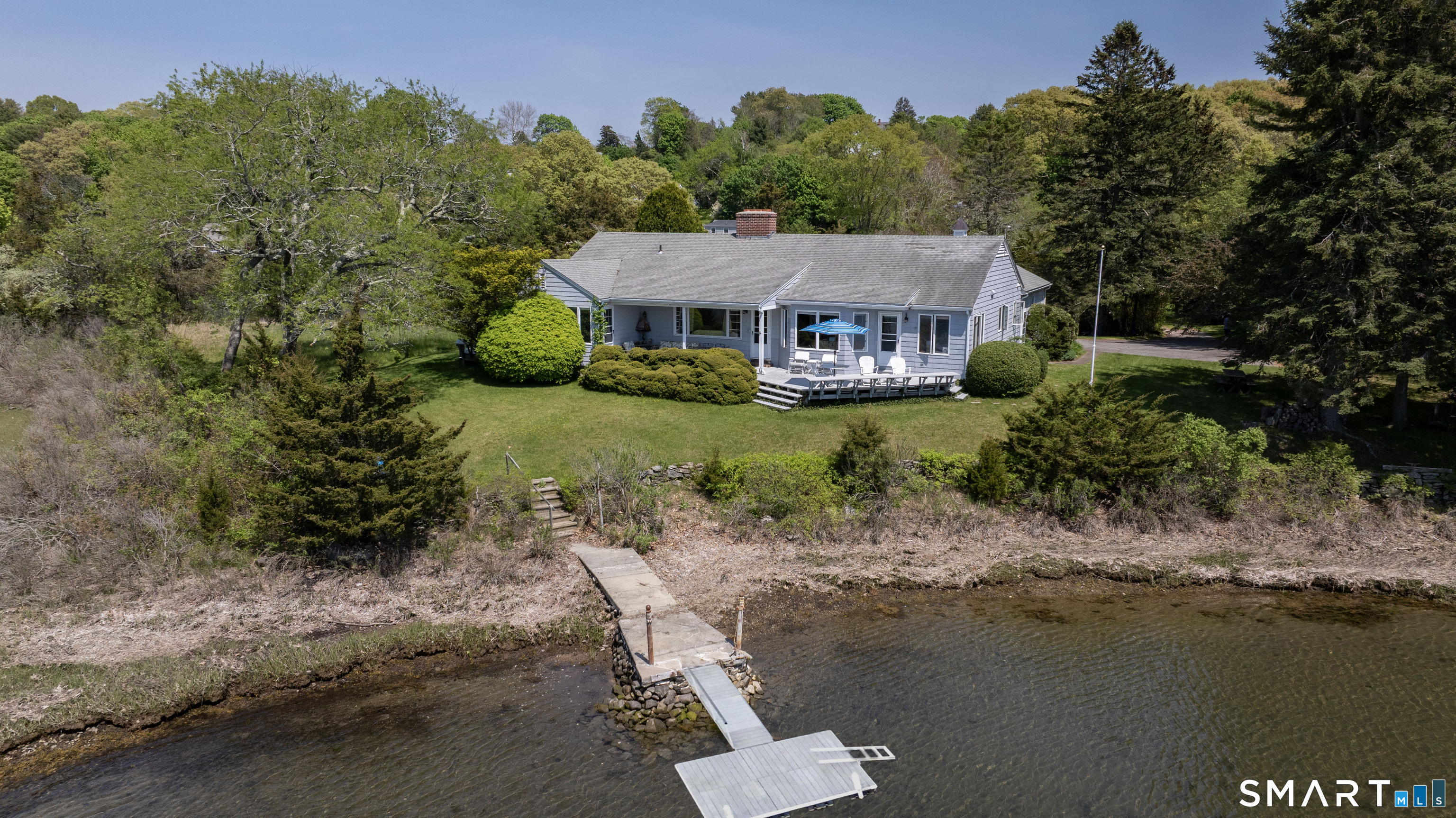 27 Wilbur Road Stonington, CT 06378 - Photo 5 of 40 a view of a house with a yard