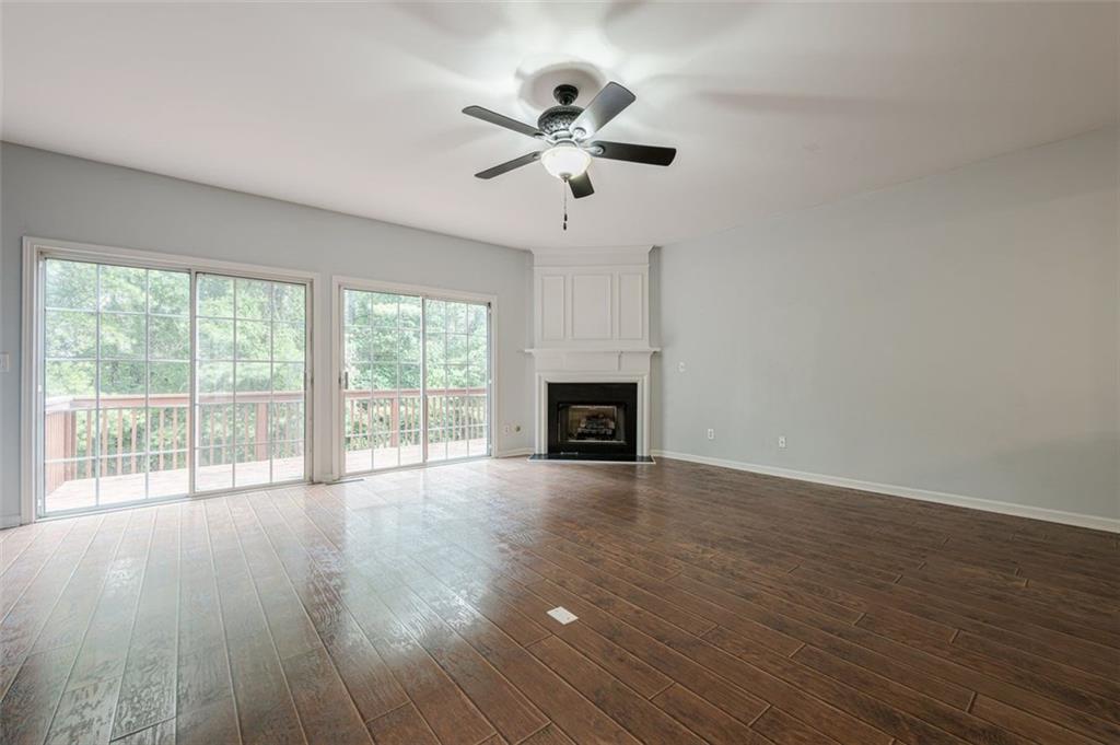 5589 Trace Views Drive Norcross, GA 30071 - Photo 11 of 58 a view of empty room with wooden floor and fan