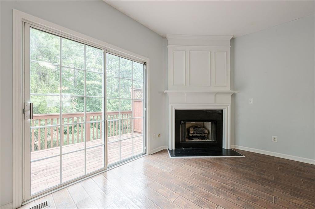 5589 Trace Views Drive Norcross, GA 30071 - Photo 13 of 58 a living room with a fireplace and a floor to ceiling window
