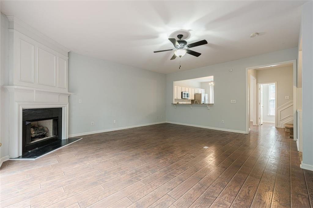 5589 Trace Views Drive Norcross, GA 30071 - Photo 15 of 58 a view of an empty room with wooden floor fireplace and a window