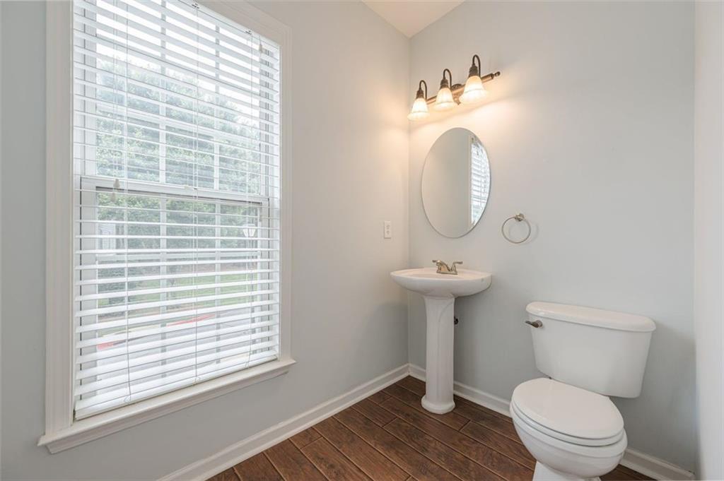5589 Trace Views Drive Norcross, GA 30071 - Photo 22 of 58 a bathroom with a toilet a sink and a mirror