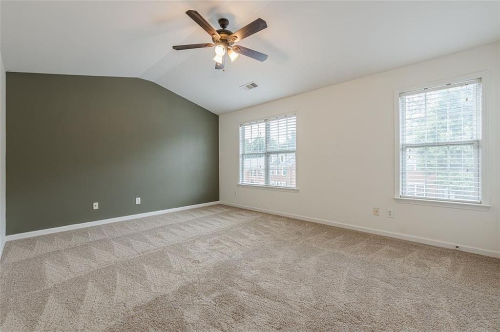 5589 Trace Views Drive Norcross, GA 30071 - Photo 25 of 58 an empty room with chandelier fan and windows