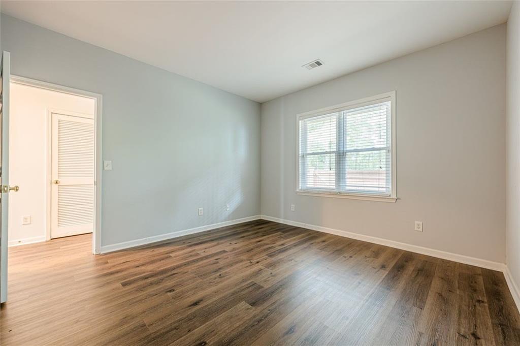 5589 Trace Views Drive Norcross, GA 30071 - Photo 8 of 58 an empty room with wooden floor and windows
