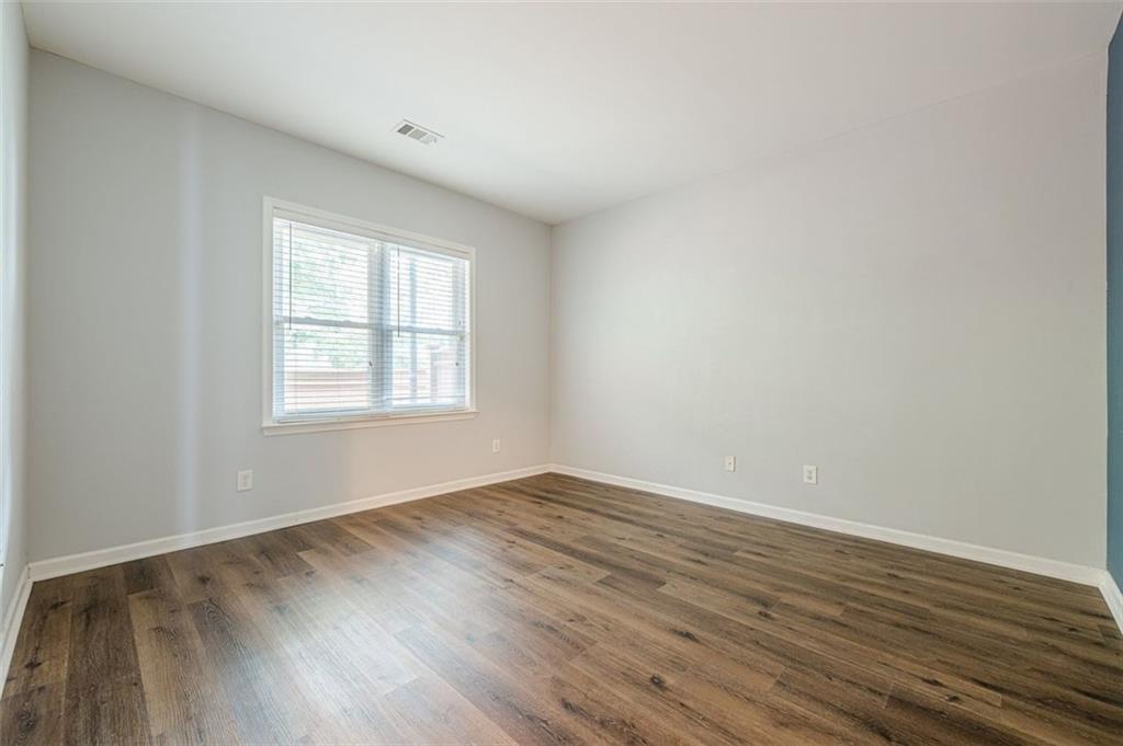 5589 Trace Views Drive Norcross, GA 30071 - Photo 9 of 58 an empty room with wooden floor and windows