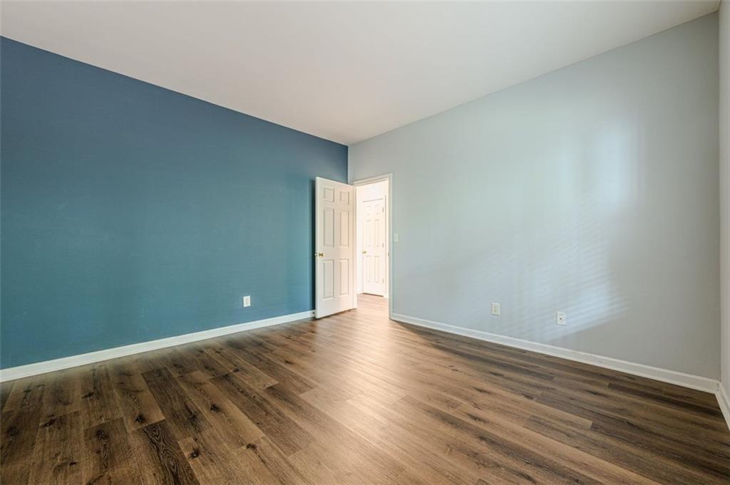5589 Trace Views Drive Norcross, GA 30071 - Photo 10 of 58 a view of an empty room with wooden floor