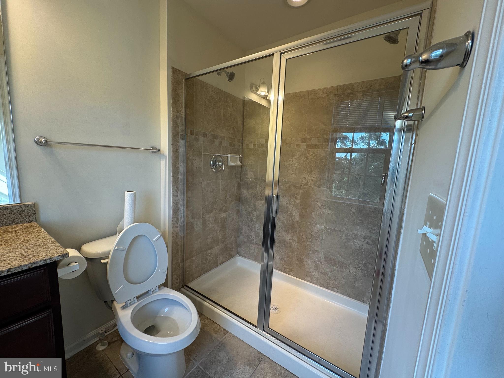 814 Susan Circle North Wales, PA 19454 - Photo 30 of 39 a bathroom with a granite countertop toilet sink and a shower