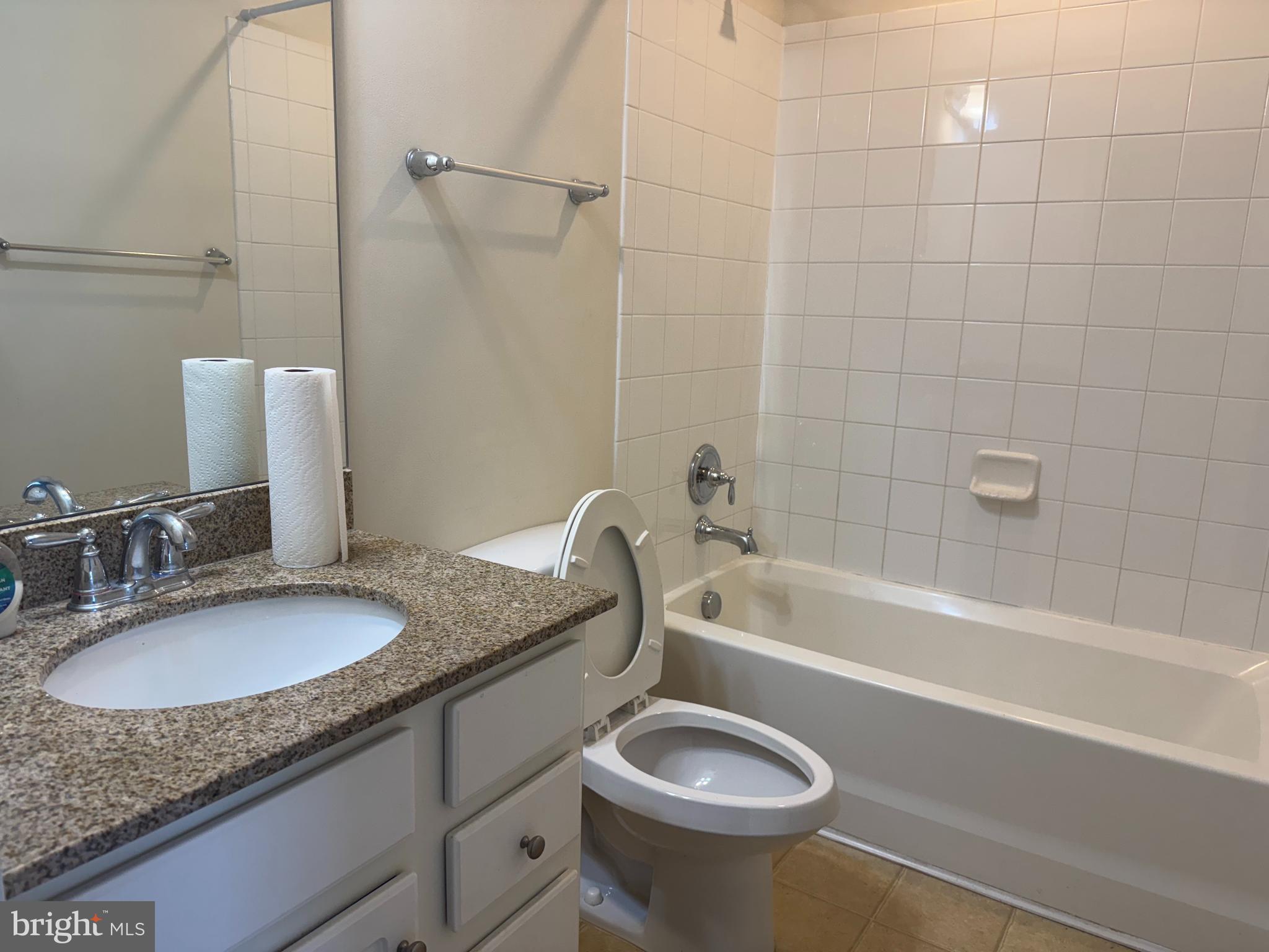 814 Susan Circle North Wales, PA 19454 - Photo 35 of 39 a bathroom with a granite countertop sink a mirror a bathtub and shower