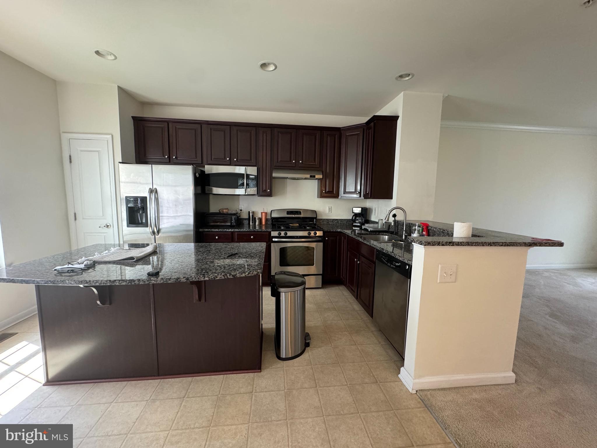 814 Susan Circle North Wales, PA 19454 - Photo 7 of 39 a kitchen with kitchen island stainless steel appliances a stove a sink a counter top space and cabinets